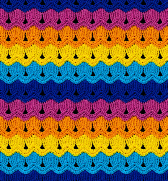 Seamless knitted texture. The pattern is crocheted from bright contrasting colors of acrylic yarn. Ethnic color motifs.