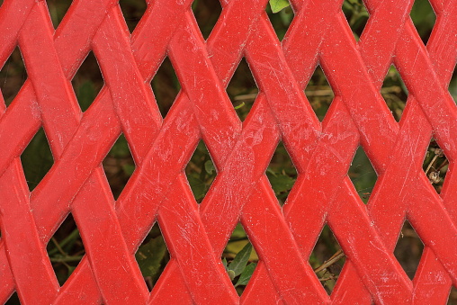 red texture of plastic dirty old grating in the wall