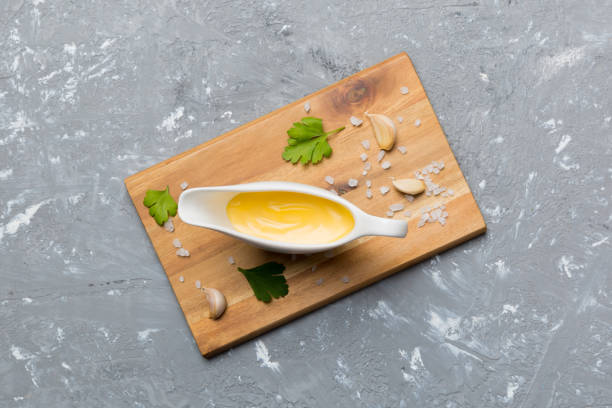 istock Gravy boat with tasty cheese sauce on table background. top view 1415464376