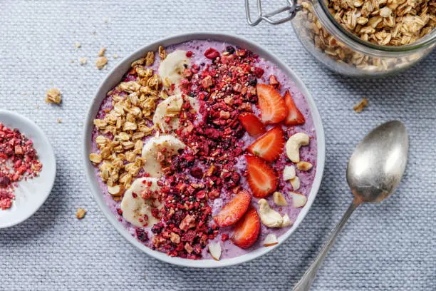 Photo of Fruity healthy muesli bowl on table