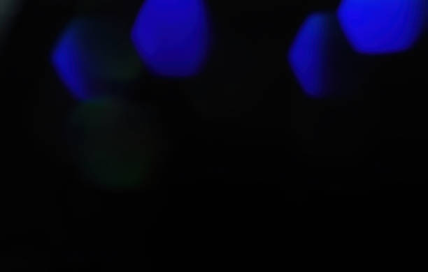 istock Large hexagon blue bokeh on black background for overlay 1415465784