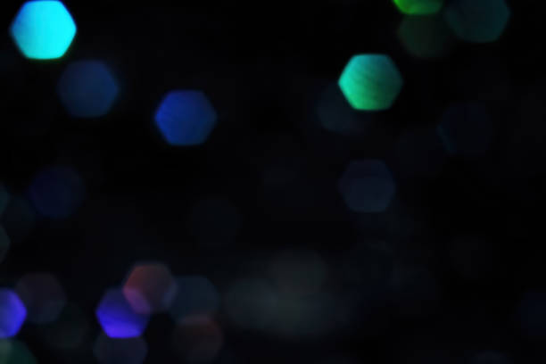 istock Large hexagon blue bokeh on black background for overlay 1415466759