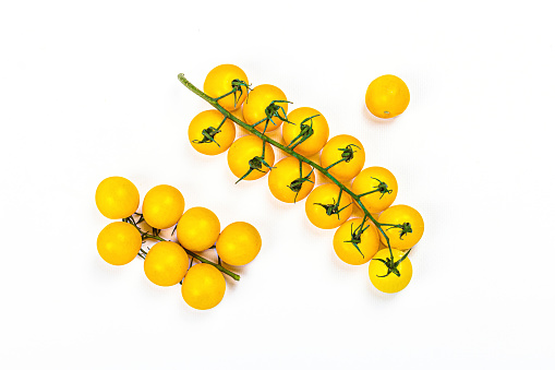 Yellow tomatoes cherry isolated on white background. Traditional ingredient for cooking healthy food, mockup, template, top view