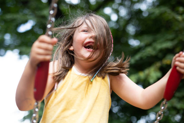 istock 8 year old girl on swing in park 1415472537
