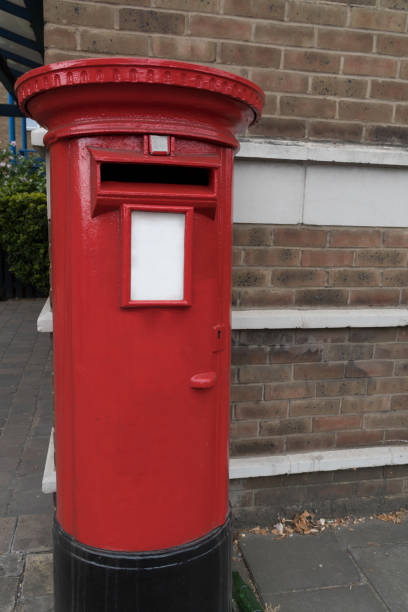 istock Closeup round metal mailbox brick wall London 1415472921