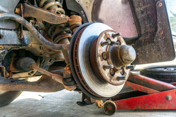 istock Replace brake disc and pads Front Disk brake assembly on an old car - Brake job in progress. 1415474202