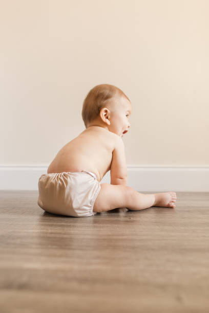 istock 7-Month-Old Baby Boy With Polydactylism Learning a New Developmental Skill of Sitting Up on His Own While Wearing a Neutral Colored Reusable Cloth Diaper 1415479888