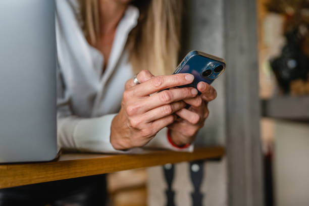 istock One caucasian woman adult entrepreneur using mobile phone at work 1415480023