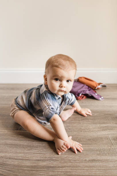 istock 7-Month-Old Baby Boy With Polydactylism Learning a New Developmental Skill of Sitting Up on His Own While Wearing a Neutral Colored Reusable Cloth Diaper 1415480029