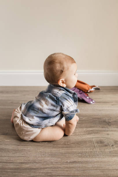 istock 7-Month-Old Baby Boy With Polydactylism Learning a New Developmental Skill of Sitting Up on His Own While Wearing a Neutral Colored Reusable Cloth Diaper 1415480071