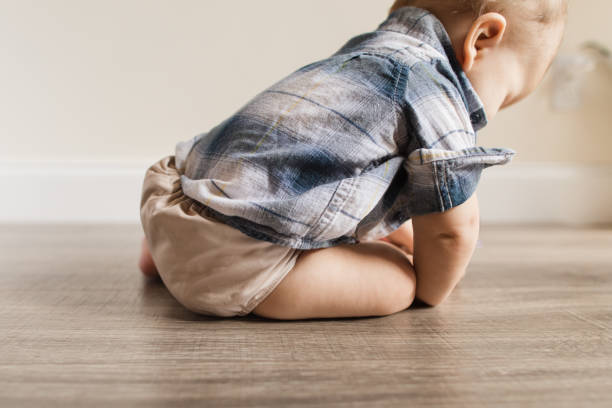 istock 7-Month-Old Baby Boy With Polydactylism Learning a New Developmental Skill of Sitting Up on His Own While Wearing a Neutral Colored Reusable Cloth Diaper 1415480087