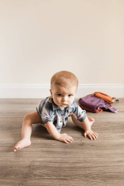 istock 7-Month-Old Baby Boy With Polydactylism Learning a New Developmental Skill of Sitting Up on His Own While Wearing a Neutral Colored Reusable Cloth Diaper 1415480125