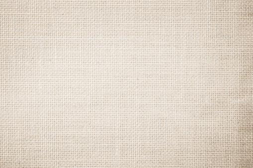 Jute hessian sackcloth burlap canvas woven texture background pattern in light beige cream brown color blank. Natural weaving fiber linen and cotton cloth texture as clean empty for decoration.