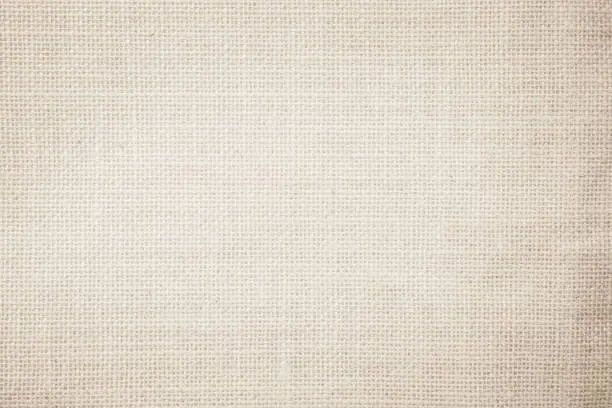 Photo of Jute hessian sackcloth burlap canvas woven texture background pattern in light beige cream brown color blank. Natural weaving fiber linen and cotton cloth texture as clean empty for decoration.