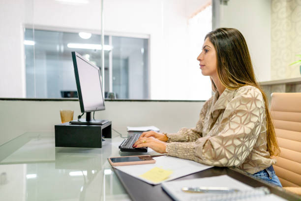 istock Young businesswoman working on a computer in her office 1415487131