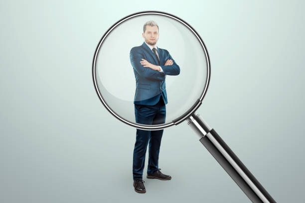 istock We are hiring, creative background flyer template. Recruiting new employees, we are looking for new candidates for our team, we have posted a vacancy. Examine the employee through a magnifying glass. 1415487480