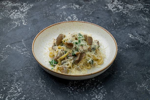 istock pasta with porcini mushrooms and truffle with spinach on dark stone table 1415487789
