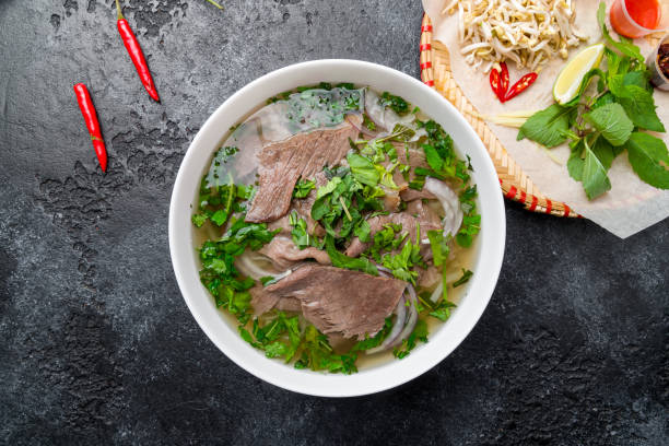 istock Soup Pho Bo with beef and noodles top view on dark stone table 1415487965