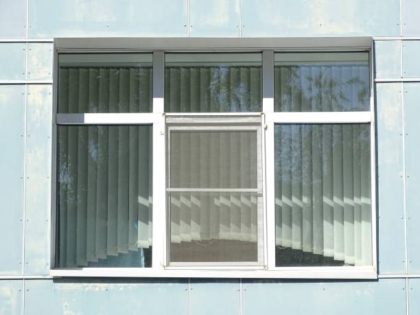 istock A white window with blinds in a blue wall. Clean and tidy. 1415490410
