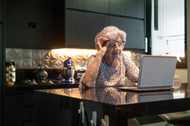 istock Senior Woman at home using a laptop 1415491260