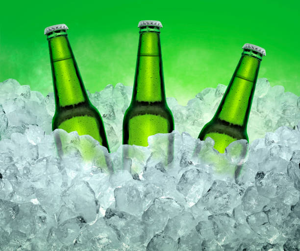 istock Three beer bottles getting cool in ice cubes. on the White color smoke background 1415492531