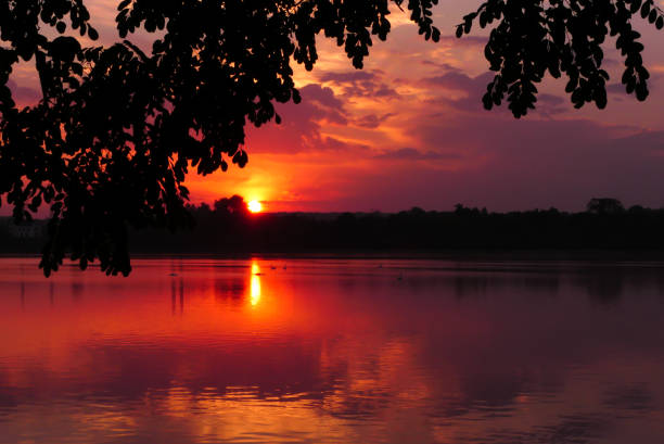 istock Dramatic sky at sunset over the water 1415493271