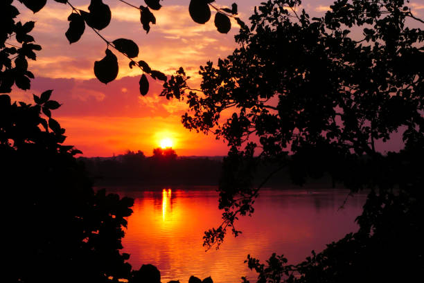 istock Dramatic sky at sunset over the water 1415493284