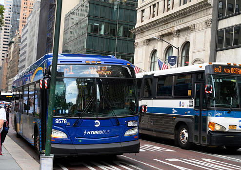 New York, New York, USA - August 10, 2022: M1 Bus on Fifth Avenue. People can be seen.