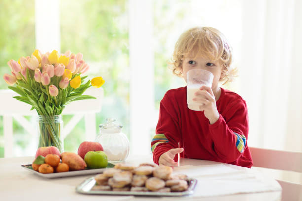 istock Child eating breakfast. Kid drinking milk. 1415495963