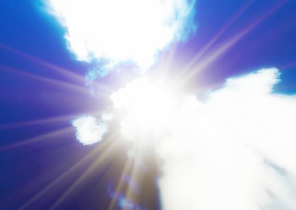 istock 3D illustration of blue sky with clouds and sun 1415499274