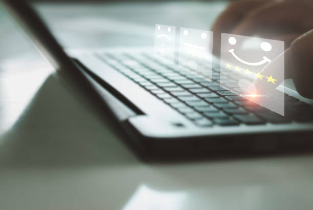 istock Businessman use laptop pressing smiley face emoticon on virtual touch screen. Assessment Survey Experience feedback business quality, service, compliments best.Customer service evaluation concept. 1415500358