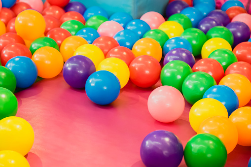 Colorful plastic balls pool background in kid playroom or playground.