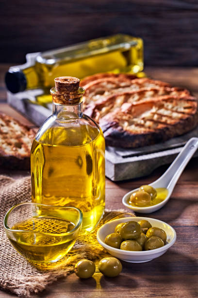 snack or appetizer of garlic basil and olive oil bruschetta on table in a rustic kitchen - bruschetta cutting board italy olive oil imagens e fotografias de stock