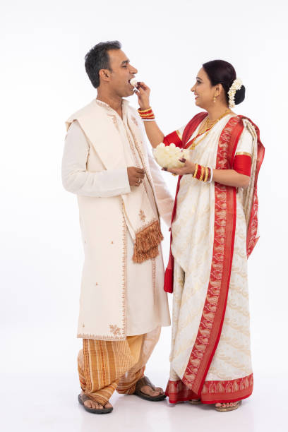 istock Bengali woman feeding a rasgulla to a man 1415506740