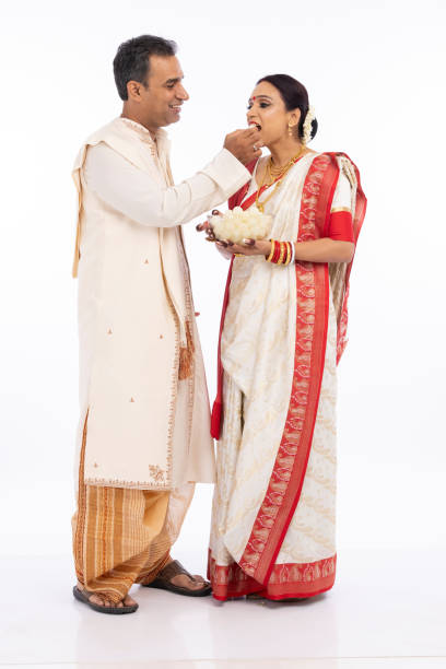 istock Bengali man feeding a rasgulla to his wife 1415506772