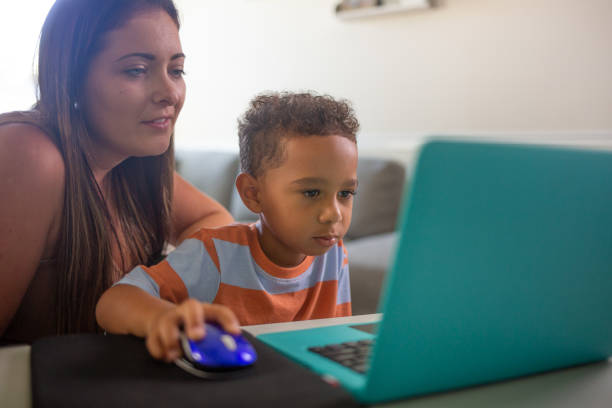 istock Mom Teaching Son, Remote Learning at Home 1415508853