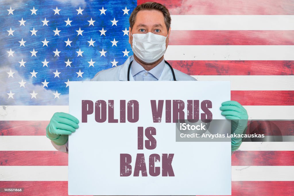 Inscription POLIO VIRUS IS BACK.Doctor holds mockup.detection of poliomyelitis virus.New polio virus infects dozens in USA.US flag background. Polio Stock Photo