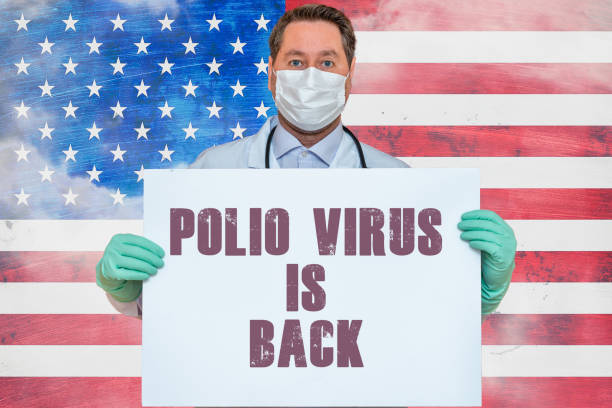 Inscription POLIO VIRUS IS BACK.Doctor holds mockup.detection of poliomyelitis virus.New polio virus infects dozens in USA.US flag background. Inscription POLIO VIRUS IS BACK.Doctor holds mockup.detection of poliomyelitis virus.New polio virus infects dozens in USA.US flag background. polio virus photos stock pictures, royalty-free photos & images