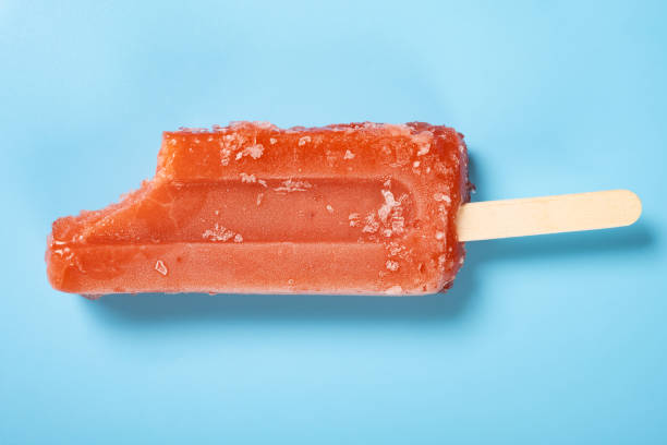 istock top view fresh red popsicle with a bite on a blue background 1415514804