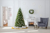 Modern Living Room With Fireplace, Christmas Tree, Gift Boxes And Armchair