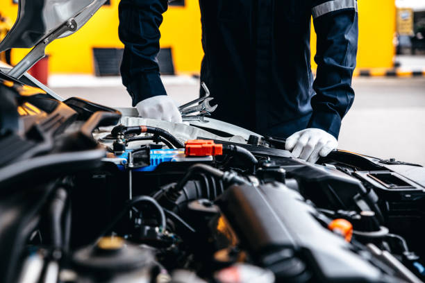 istock Mechanic working with wrench while inspecting car at garage workshop. 1415515183