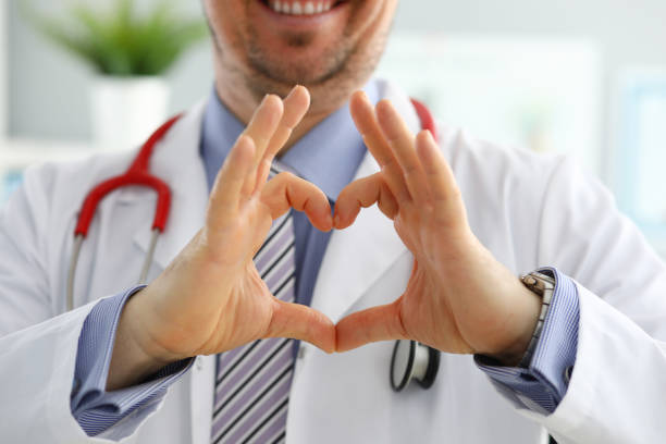 male medicine doctor hands showing heart shape - förebyggande sjukvård bildbanksfoton och bilder