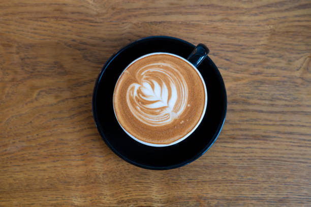 istock Cup of hot latte coffee on wooden table 1415520852