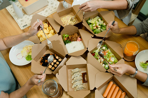 Asian families order food from their favorite restaurant to eat together.