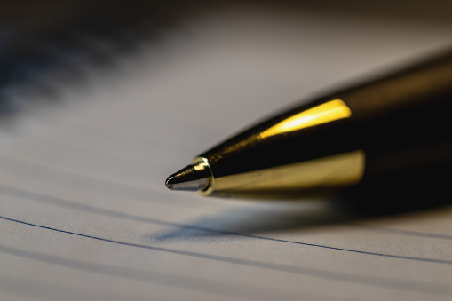 signing a document with an ink pen fountain