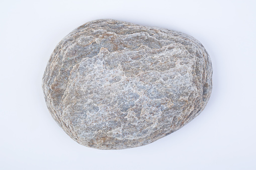 Natural specimen of fine-grained granite, the best-known intrusive igneous rock composed mainly of quartz and feldspar with minor amounts of mica, amphiboles, and other minerals on white background
