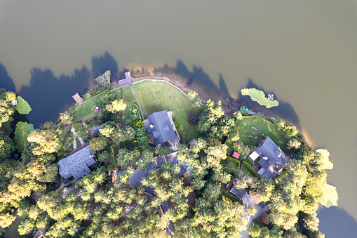 Aerial view of house in forest and lake