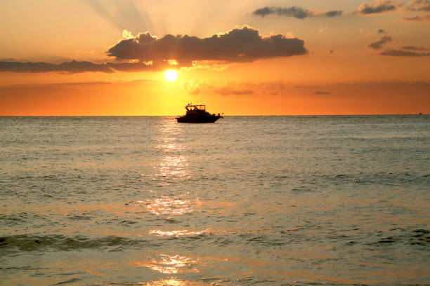 Colorful beautiful seascape with boat during sunset Seascape during sunset in Sarasota, Florida beautiful multi colored tranquil scene enjoyment stock pictures, royalty-free photos & images