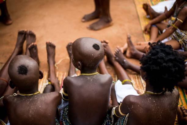 Dipo Rites Festival is a rite of passage ceremony celebrated by the people of Odumase Krobo in Ghana. Despite the influences of modernity and education, the rite is still being practised. It is a festival that ushers virgin girls into puberty in April every year. \nDuring this period, the maidens are taken through various rituals to ascertain their chastity before they are qualified for the next stage, which is the Dipo rites.\nDipo rites are characterised by the girls shaving their heads and being clad in cloth around their waists with a special ritual mother who performs the rites and leads them in a parade through the entire community to transition them from childhood to adulthood on the first day.\n\nBefore the sun rises the next day, the girls are given a ritual bath by the chief priest and he pours libation to ask for blessings. Then he washes their feet with the blood of a goat that was presented by the mothers of the maidens. They believe that washing the girl's feet with the goat's blood purges the girls from any spirit of barrenness. \nAfter this, the girls are made to sit on a sacred stone which, they believe is used to check their virginity. If found pregnant or not to be a virgin, the community detests that girl and is not attractive to any man from the Krobo tribe. \nThe girls are then taken through a week of tutorials on housekeeping, cooking, childbirth and nurturing and how to please their future husbands. They are also taught the traditional Klama dance which they perform on the final day of the Dipo rites. \n\nThe rites come to an end at a grand ceremony with all the members of the community gathered to celebrate the maidens as they transition into womanhood amidst drumming, singing and cheers.
