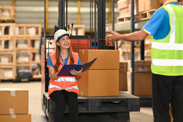 istock Industrial worker and manager with safety hard hat and vest checking quantity of storage product on shelf in a large warehouse. 1415534065